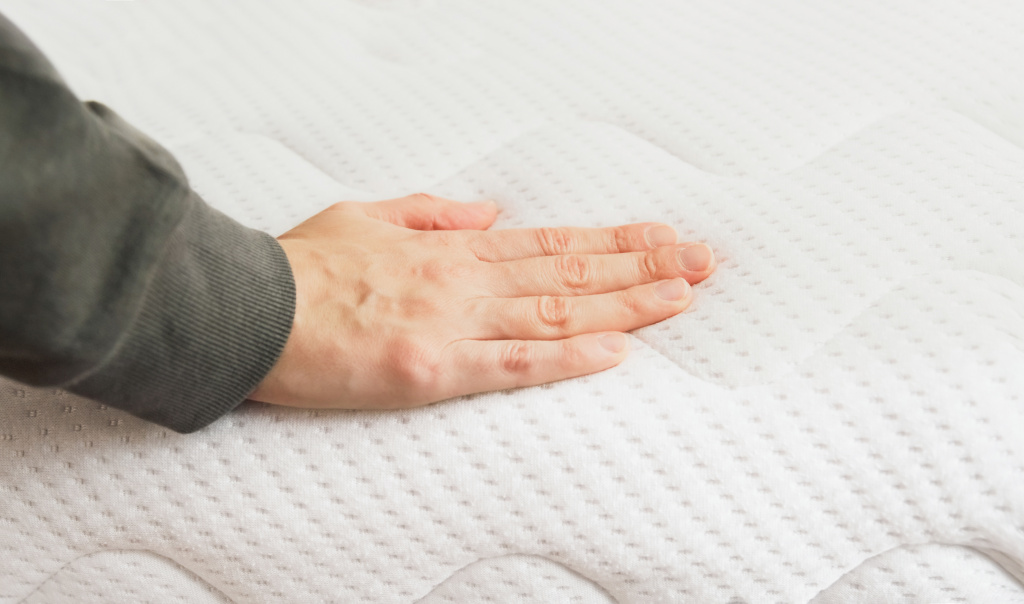 hand-touching-orthopedic-mattress-bed.jpg
